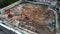 Aerial Shot of the Building in the Process of Construction a house. In the Background Working Crane and city