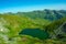 Aerial shot of the calm lake Capra in the beautiful Fagaras mountains located in Romania