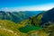 Aerial shot of the calm lake Capra in the beautiful Fagaras mountains located in Romania