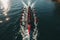 Aerial shot capturing rowers in the sea, displaying synchronized perfection