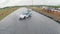 Aerial shot of cars drifting during drift competition named. Clip. Car race aerial view. Racing track and drifting cars