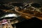 Aerial shot of cars driving on the freeway with skyscrapers and office buildings in the city skyline at night in Atlanta Georgia