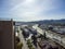 Aerial shot of cars and truck driving on Interstate 5 surrounded by buildings, lush green trees and mountains