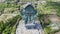 Aerial shot circling the Garuda Wisnu Kencana statue in Bali, Indonesia. Famous religious statue with residential neighborhoods i