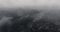 Aerial shot of the city and the road in the black forest in the mountains under the clouds