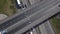 Aerial shot of city road traffic over big crossroad. Cars, buses and trucks driving by avenue. Vertical view.