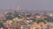 Aerial shot of the cityscape of the central Agra in smog with Taj Mahal in the background