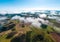 Aerial shot of the cloudscapes with cultivated land fields in the background