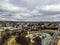 Aerial shot of country town buildings, main street, dry trees and the skyline in Armidale, Australia