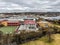 Aerial shot of country town buildings, trees, clouds and the skyline in Armidale, Australia