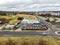 Aerial shot of country town main street,parking lots, cars, and the skyline in Armidale, Australia