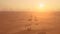 Aerial shot. Couple in the car, stands on the road after sandstorm. Silhouette Dubai city at the sunset.