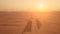 Aerial shot. Couple in the car, stands on the road after sandstorm. Silhouette Dubai city at the sunset.