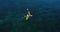 Aerial shot of couple kayaking in turquoise sea during summer day