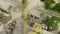 Aerial shot of crane claw loading rubble into conveyor at concrete factory