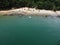 Aerial shot of the Da Barra Do Sahy sandy beach with vacationers against the clear sea