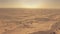 Aerial shot of desert tour cars driving on sand dunes in UAE