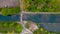 aerial shot of a drawbridge over a canal or river in a green countryside landscape in Flanders, Belgium