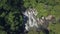 Aerial shot with drone at Bali island of Indonesia in Asia flying over beautiful waterfall in the middle of the jungle