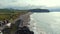 Aerial shot, drone point of view picturesque landscape view, group of people sunbathing in volcanic coastline. San Miguel Island,