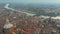 Aerial shot of Duomo di Pavia cathedral and the Ponte Coperto Bridge within the cityscape of Pavia, Italy