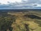 Aerial shot of empty grassy field with trees in Salamanca, Spain