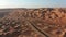 Aerial shot of empty road in desert dunes