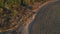 Aerial shot of farmer jeep riding through empty rural road among field. Off road vehicle speeding on dusty route at dusk