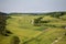 Aerial shot of farmland under the clear sky in the Eifel region, Germany