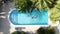 Aerial shot of a female swimming in the pool of a private villa in Barcelona