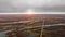 Aerial shot of the field with lakes, a road and a small settlement at sunset. North Shoal Lake, Manitoba, Canada