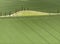 Aerial shot of field with a tractor strips and agricultural way