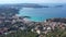 Aerial shot flying towards Peguera from mountain side with hotels and beaches. Sea in background. Mallorca, Balearic Islands,