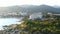 Aerial shot flying towards Peguera from sea side with hotels and beaches. Mountains in background. Mallorca, Balearic Islands