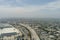 aerial shot freeway with cars and trucks driving with the Los Angeles Convention Center, office buildings, apartments