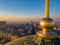 Aerial shot of the golden cross on top of Saint Sava temple cupola in Belgrade with Terazije and Beogradjanka building in the