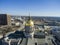 Aerial shot of the golden dome of Georgia Capitol Museum surrounded by office buildings and cars driving on the street