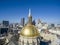 Aerial shot of the golden dome of Georgia Capitol Museum surrounded by office buildings and cars driving on the street