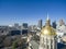 Aerial shot of the golden dome of Georgia Capitol Museum surrounded by office buildings and cars driving on the street