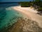 Aerial shot of green island and tranquil sea