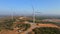 Aerial shot of a group of wind turbines in a semidesert environment. Green energy concept