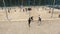 Aerial shot group of young people compete basketball at beach sports ground