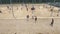 Aerial shot group of young people playing basketball at beach sports ground