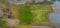 Aerial shot of the harbor embankment of Vlissingen, stones covered in green seaweed with ship anchor decorations, dutch landscape