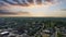 aerial shot of hotels, office buildings and apartments in the city skyline and vast miles of lush green trees and grass