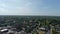 aerial shot of hotels, office buildings and apartments in the city skyline and vast miles of lush green trees and grass