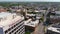 aerial shot of hotels, office buildings and apartments in the city skyline and vast miles of lush green trees and grass