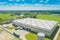 Aerial Shot of Industrial Warehouse Area where Many Trucks Are Loading Merchandise