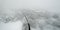 Aerial shot of the Italian Apennines road covered in snow in Vezzolacca, Italy