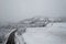 Aerial shot of the Italian Apennines road covered in snow in Vezzolacca, Italy